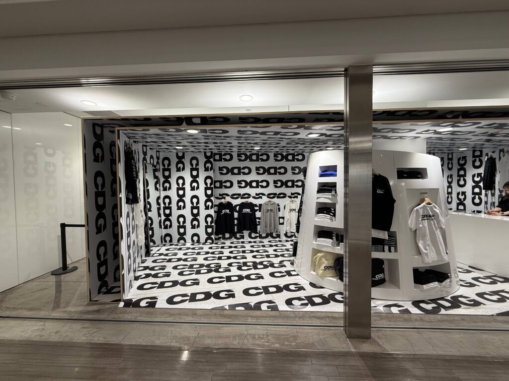 CDG store interior product display CDG logo T-shirts and sweatshirts