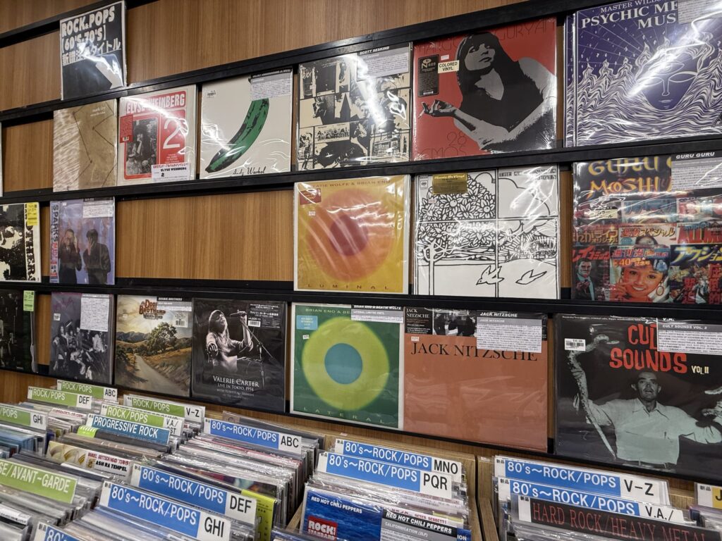 Shelves packed with numerous records in the new records section of Disk Union Ochanomizu store.