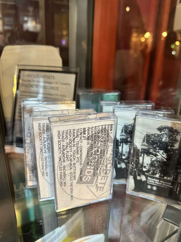 Discrete Records Mixtape cassettes on a record store shelf.