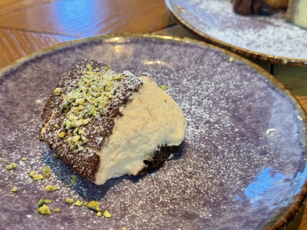 Fluffy tiramisu with rich dark chocolate sponge and pistachio accents