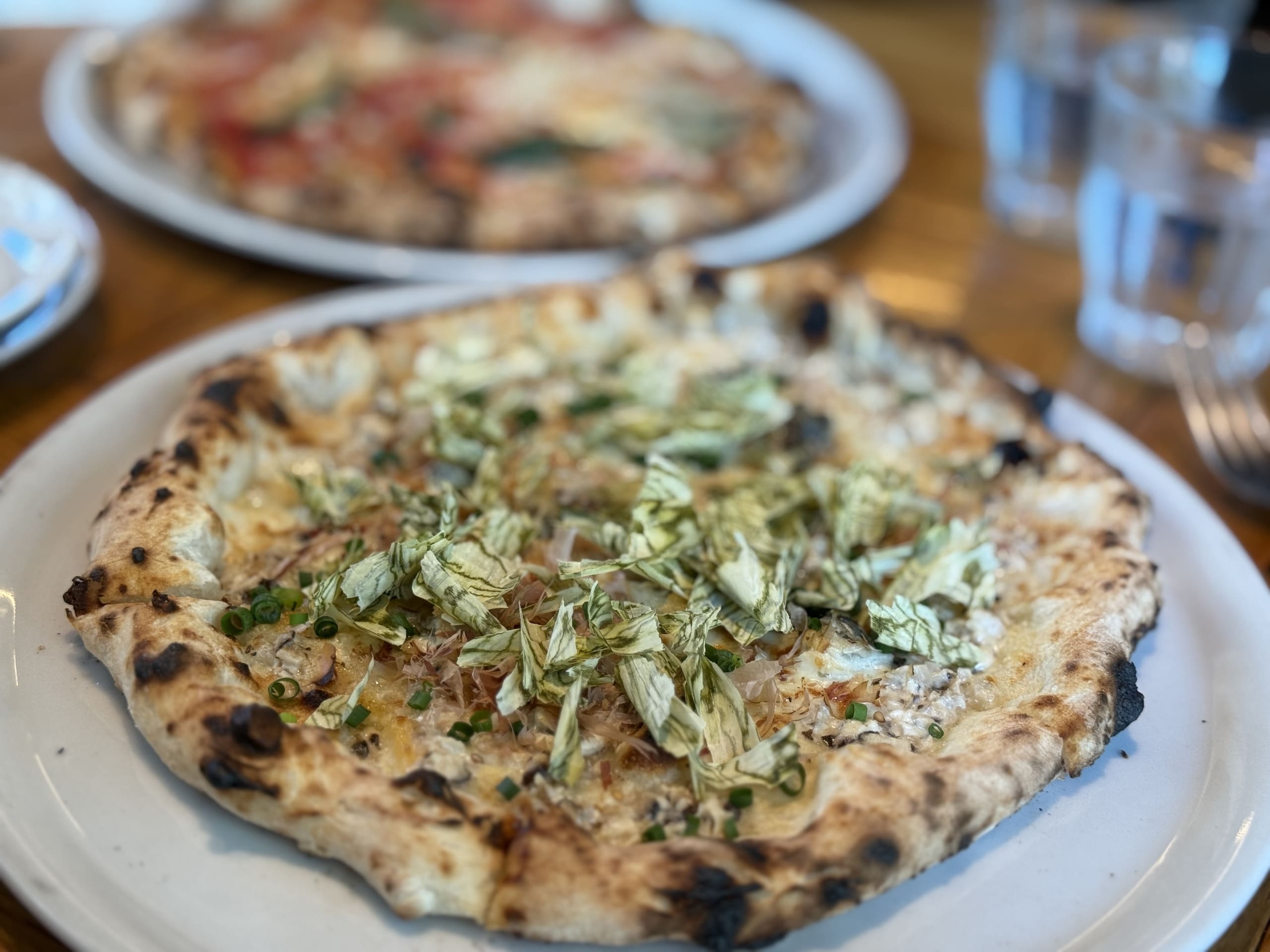 Close-up shot of an Umami Pizza, topped with savory mackerel.