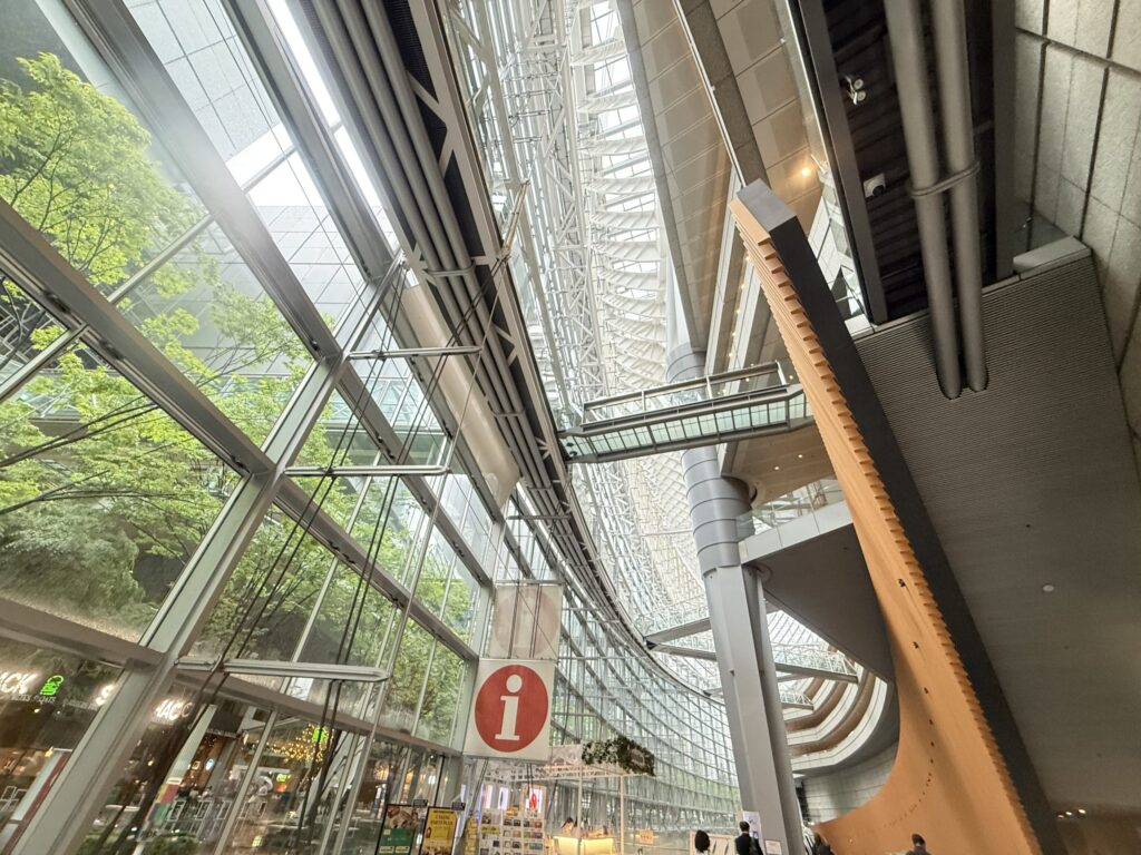 Modern building atrium viewed from the basement level, looking up.