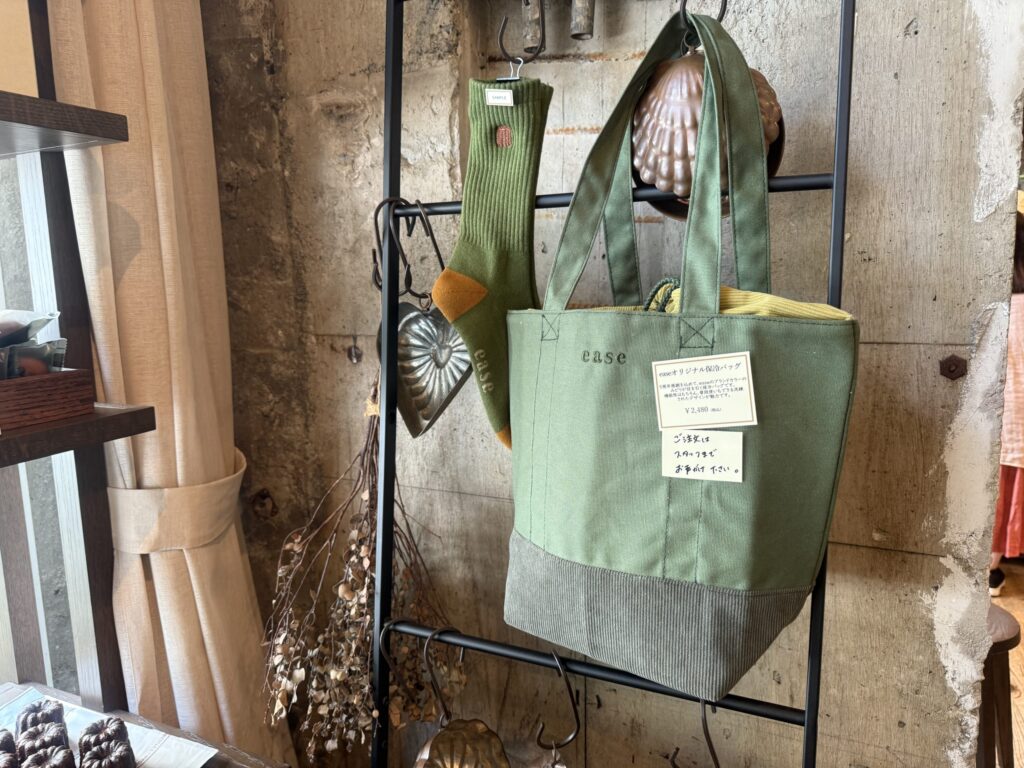 A light blue cooler bag and three pairs of character-designed socks on display.