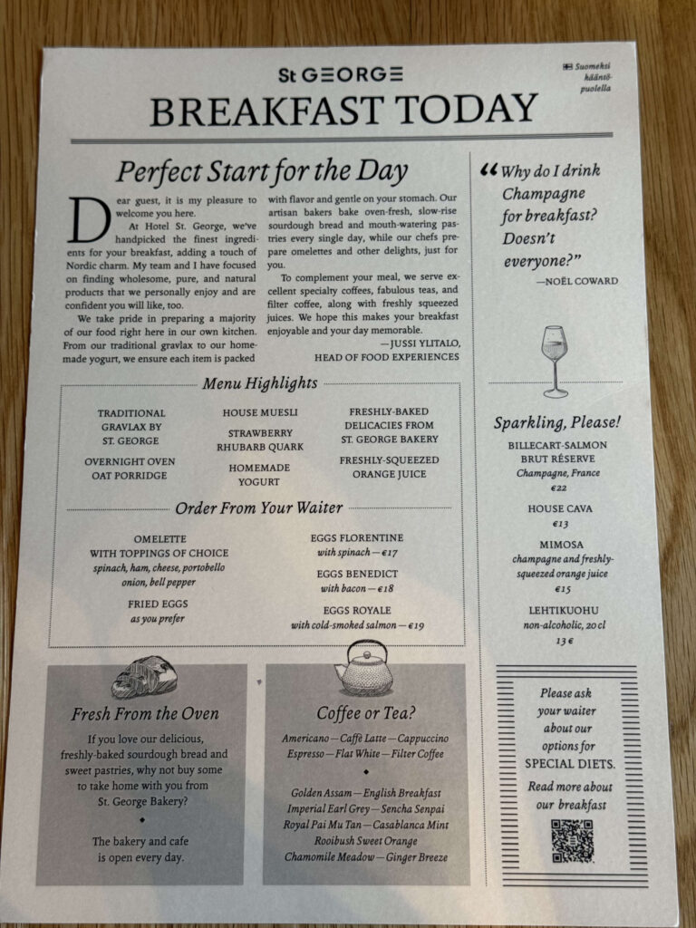 A newspaper-style breakfast menu from the St. George Hotel, placed on a wooden table.