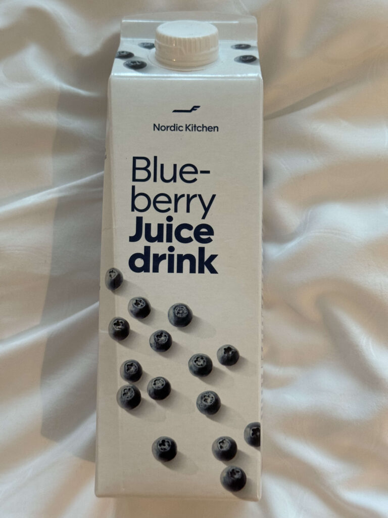 A carton of Nordic Kitchen's popular blueberry juice, served on Finnair, placed on a white cloth.