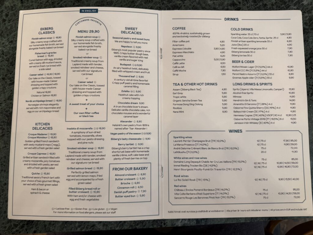 The English menu of Café Ekberg in Helsinki, placed on a green marble table.