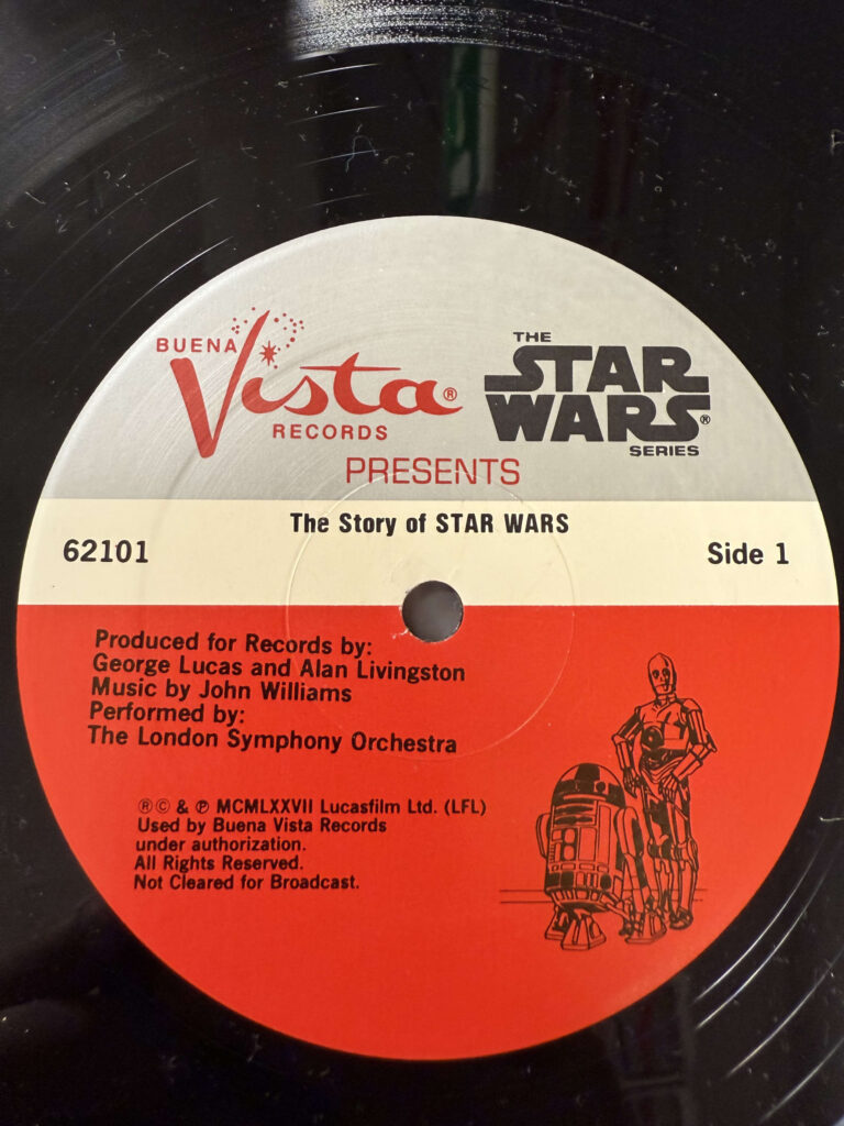 A close-up of the record label for 'The Story of STAR WARS.' The white and red label features an illustration of R2-D2 and C-3PO.
