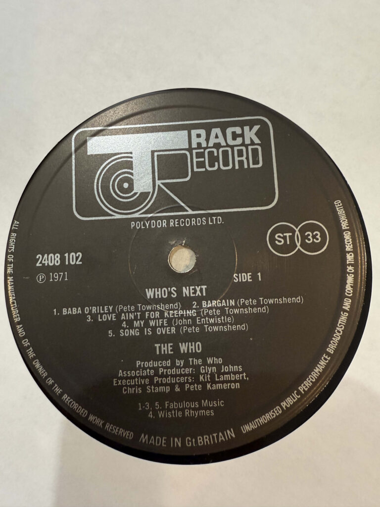 A close-up of the black Track Record label on Side A of the UK vinyl LP of The Who's album 'Who's Next'.