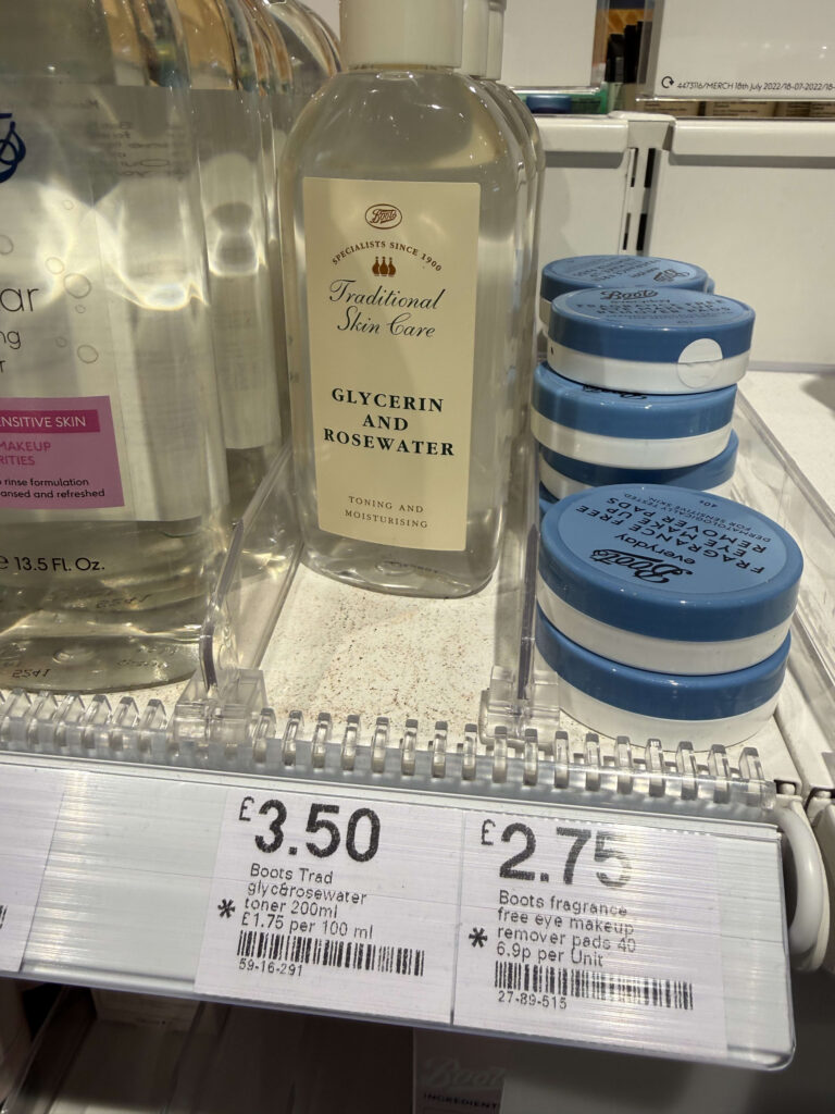 A bottle of Boots Glycerin and Rosewater toner priced at £3.50 on a shelf next to stacks of eye makeup remover pads priced at £2.75