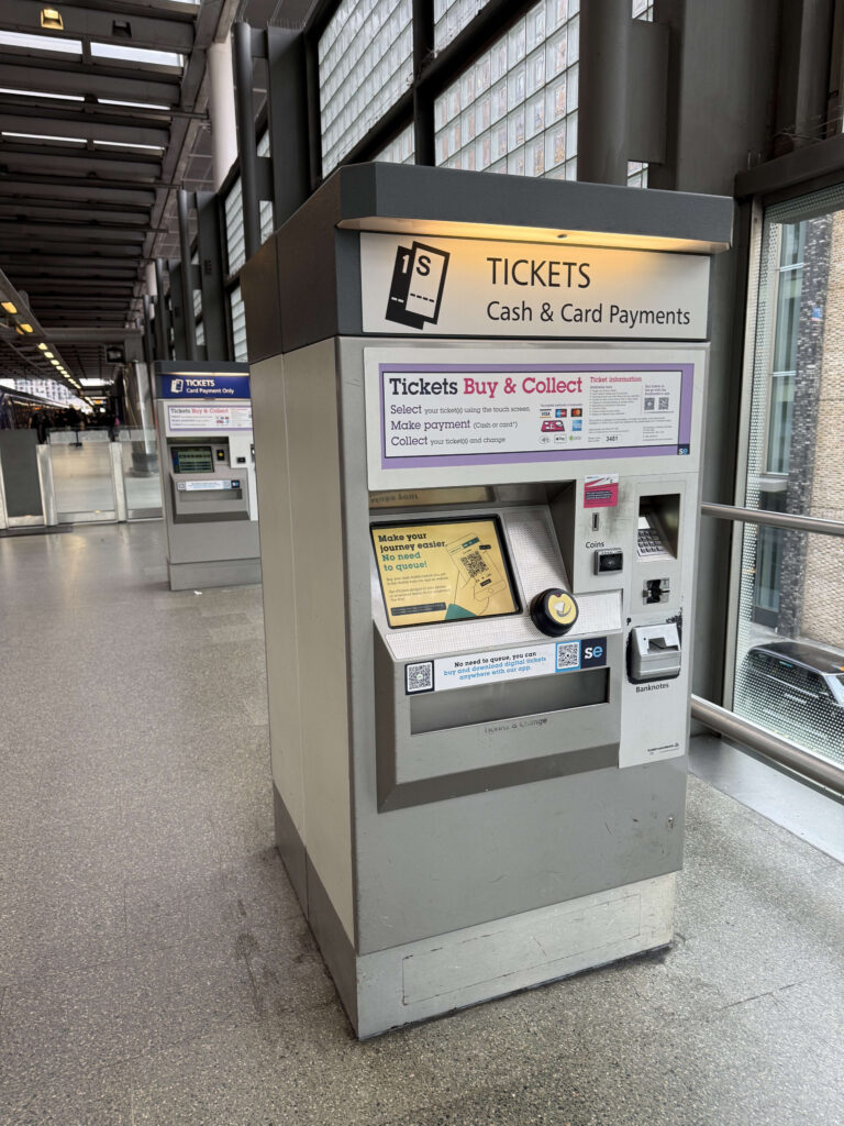 駅のホームに設置された、現金とカード払いに対応した灰色の券売機。