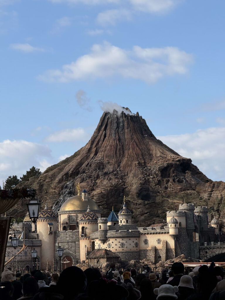 Mount Prometheus at Tokyo DisneySea rising above Fortress Explorations under a blue sky