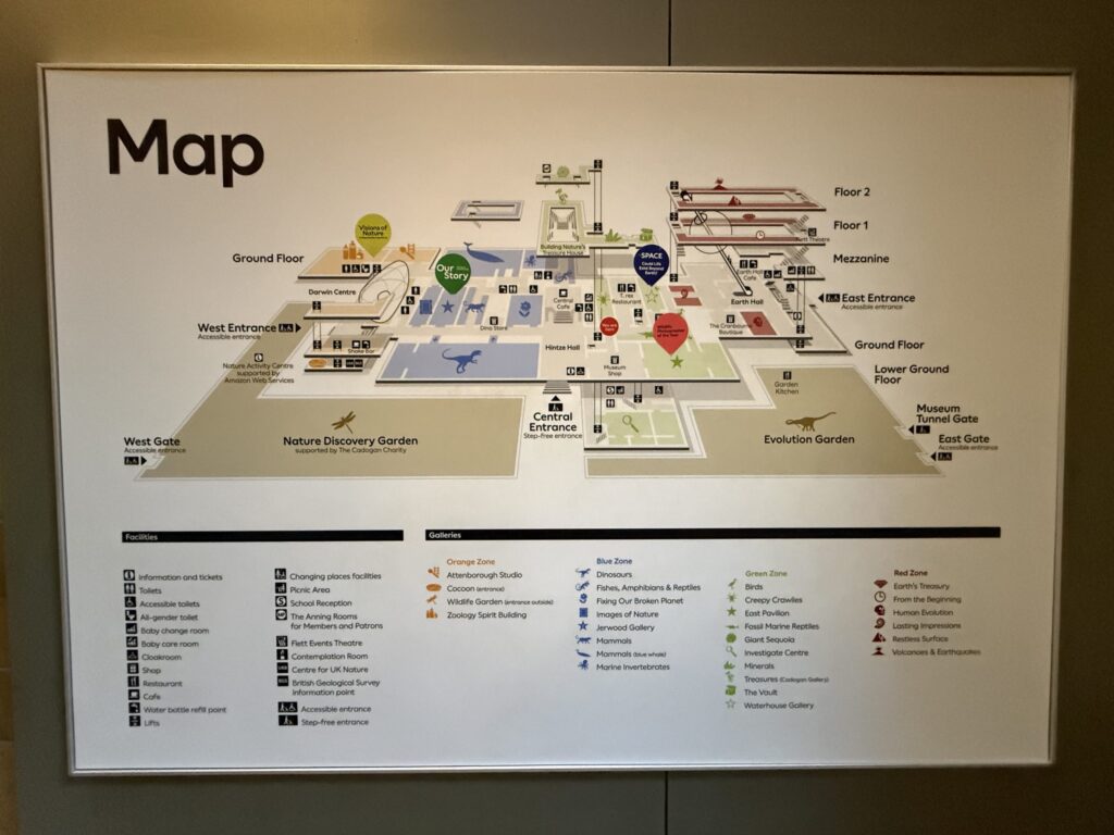 Wall-mounted guide map of the Natural History Museum, showing color-coded zones and floor plans