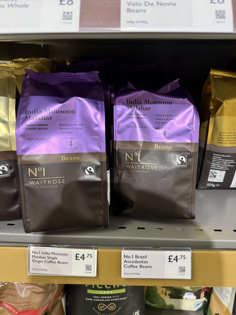 Purple bags of Waitrose No.1 India Monsoon Malabar single origin coffee beans on a supermarket shelf