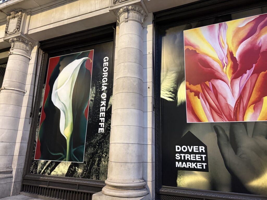 Exterior of Dover Street Market London featuring shop windows displaying Georgia O'Keeffe floral paintings