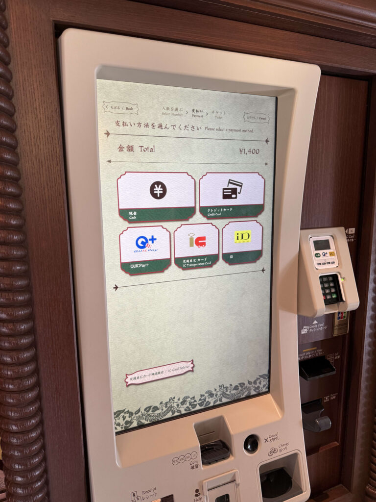 Touchscreen ticket vending machine showing payment options: Cash, Credit Card, QUICPay, IC Transportation Card, and iD. The total amount shown is 1,400 yen.