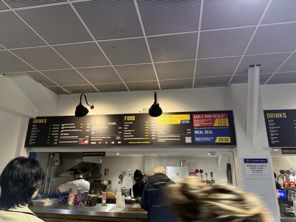 Menu boards and counter at a stadium concession stand