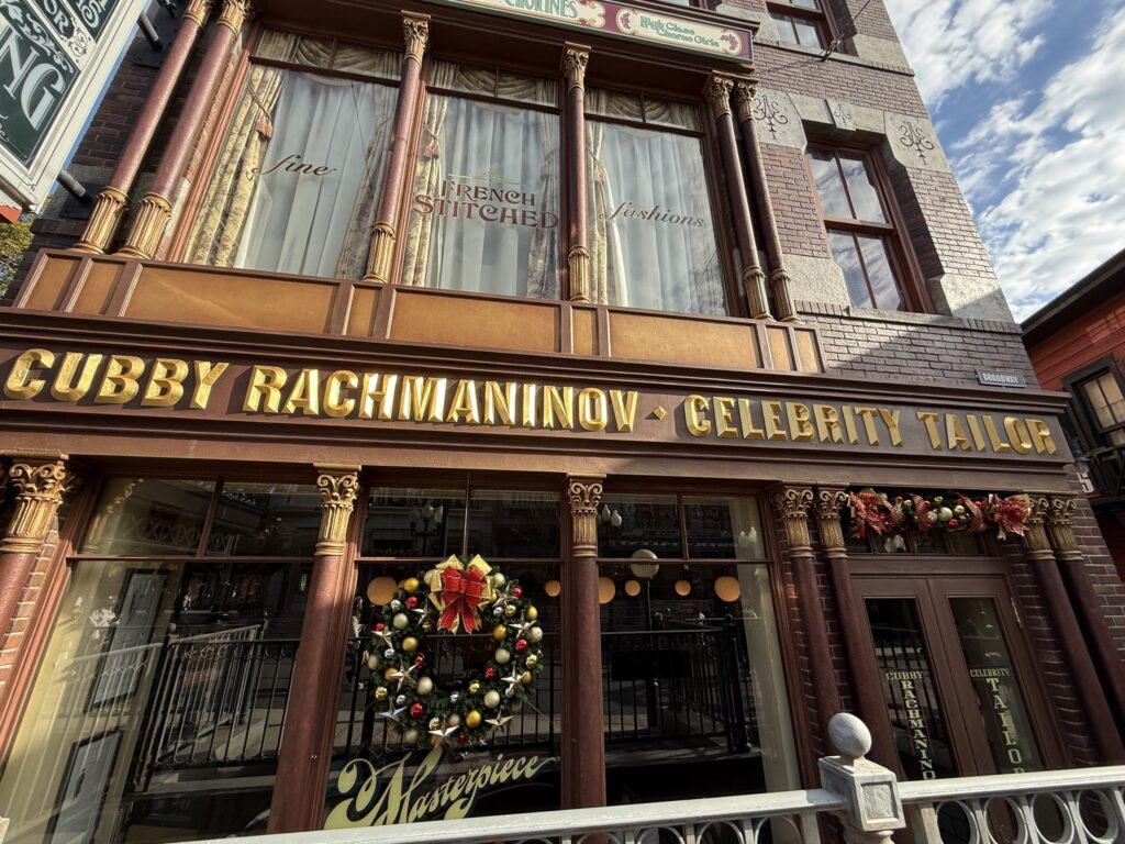 Facade of the Cubby Rachmaninov Celebrity Tailor building featuring gold lettering and a Christmas wreath on the window