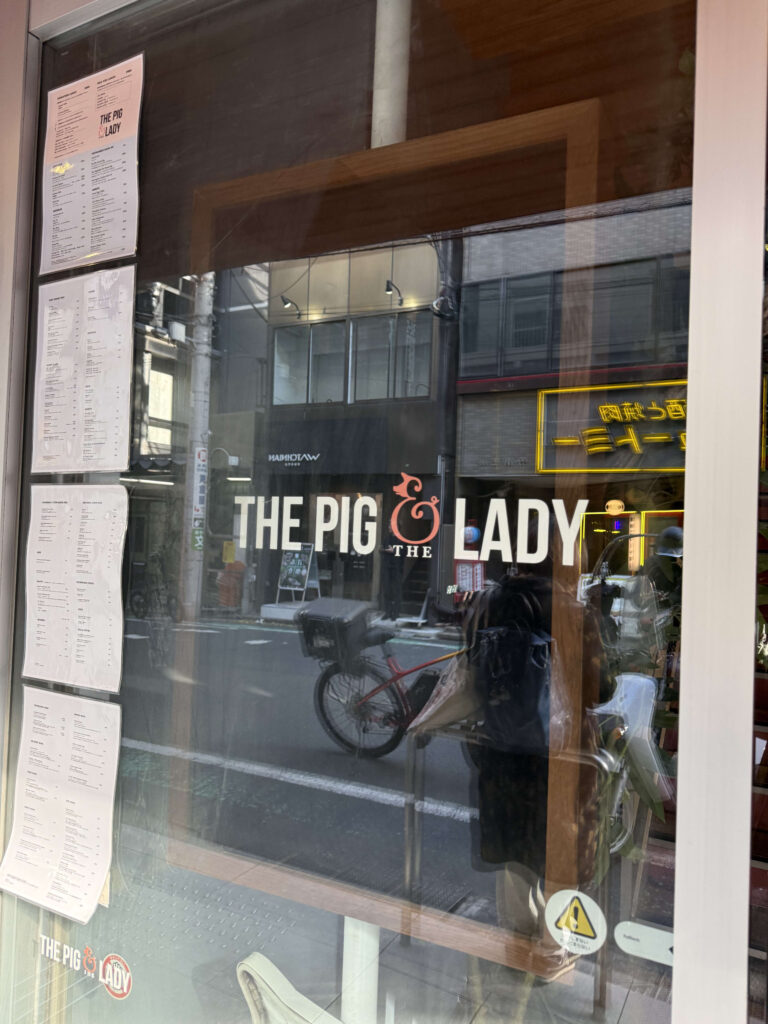 Glass storefront entrance displaying 'THE PIG & THE LADY' logo and menus