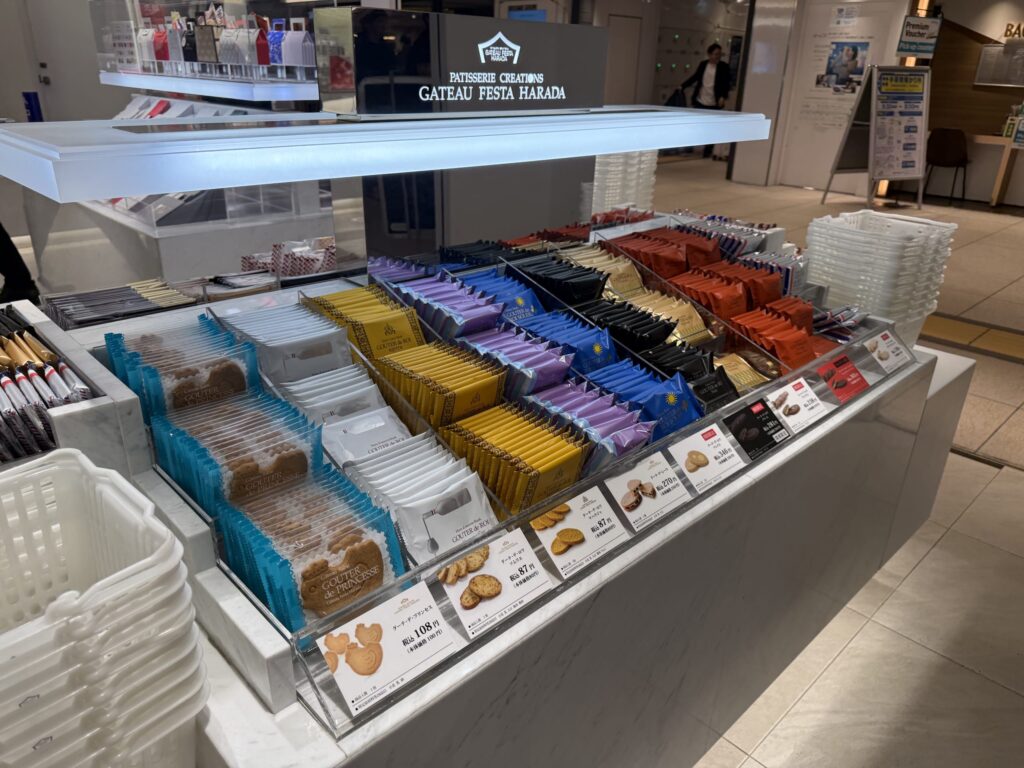 Display shelf at Gateau Festa Harada featuring Gouter de Princesse bird-shaped sables and colorful rusk packages