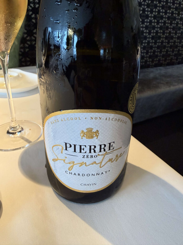 Chilled bottle of Pierre Zéro Signature Chardonnay non-alcoholic sparkling wine with condensation droplets