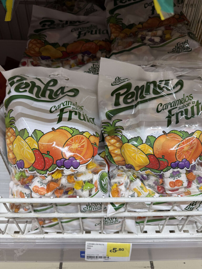 Bags of Penha brand fruit flavored caramels displayed on a supermarket shelf