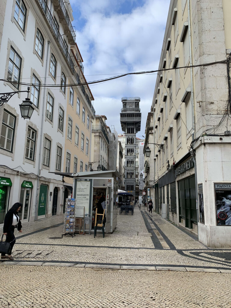 The Neo-Gothic Santa Justa Lift standing at the end of Rua de Santa Justa in Lisbon under a blue sky