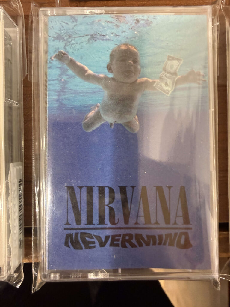 Nirvana 'Nevermind' cassette tape featuring the iconic cover art of a baby swimming underwater