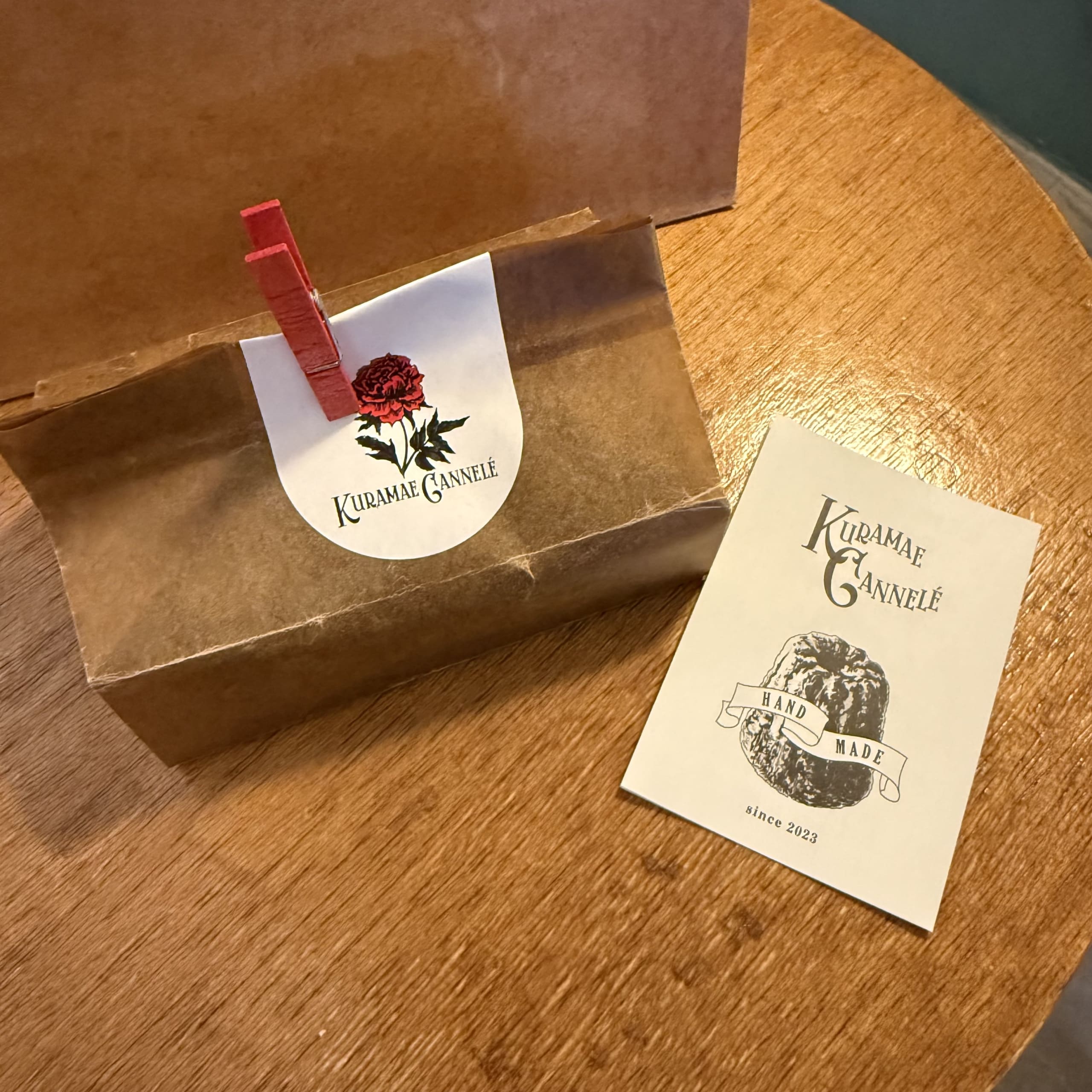 Kuramae Cannele craft bag and card on a wood table.