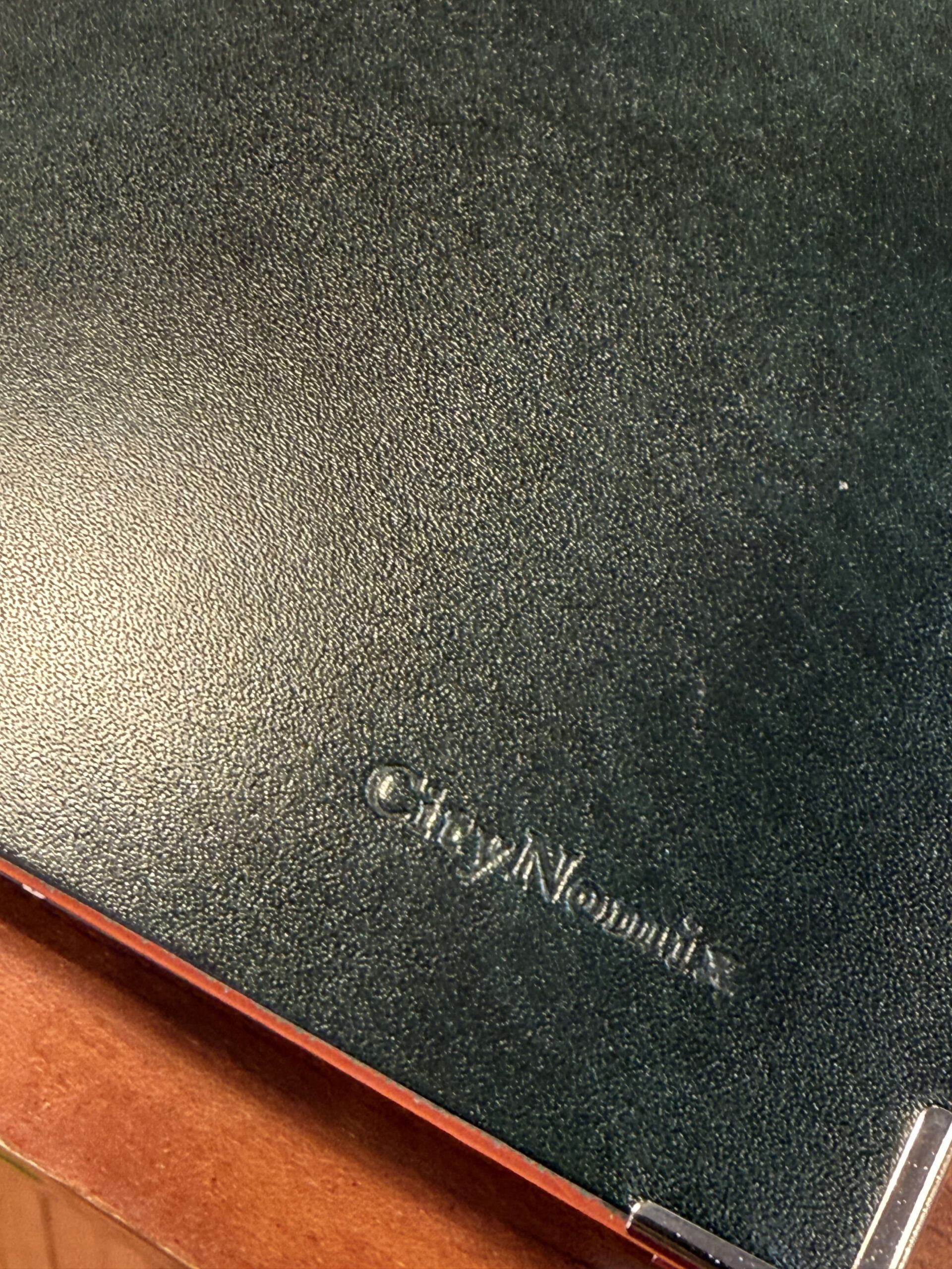 Green leather notebook with CityNomix logo