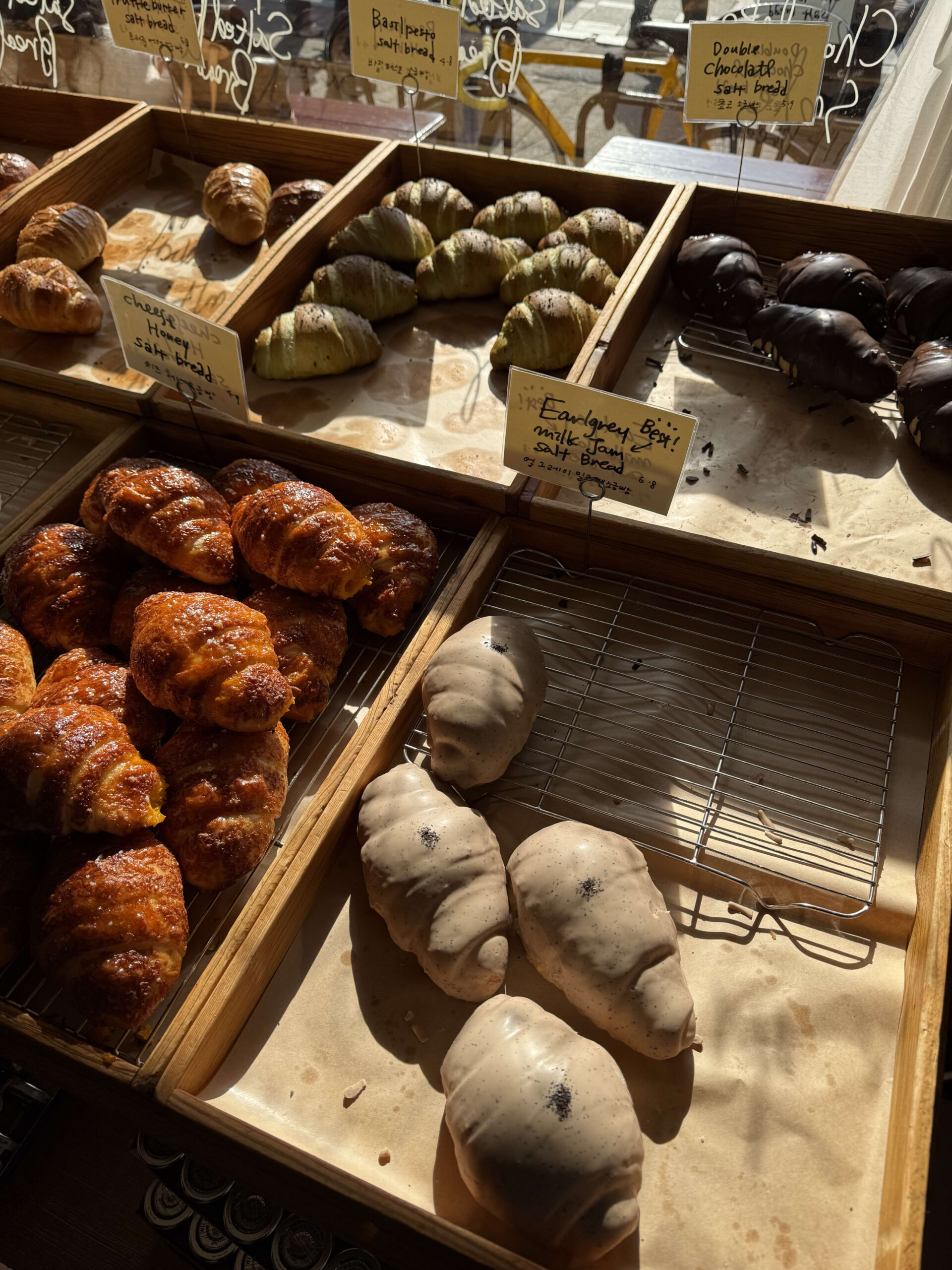 Various salt breads in wooden boxes lit by morning sun.