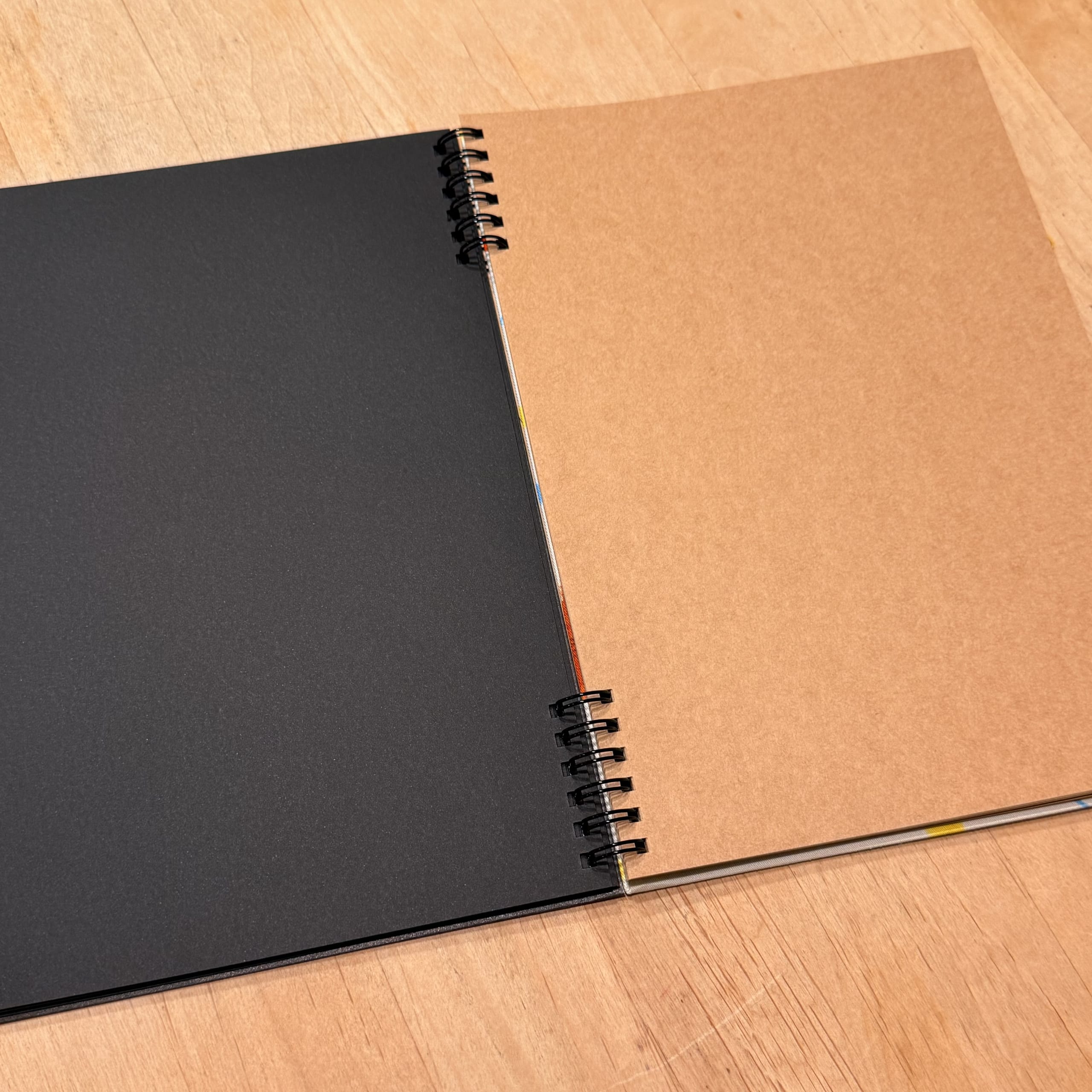 Open ring notebook with black and brown pages.