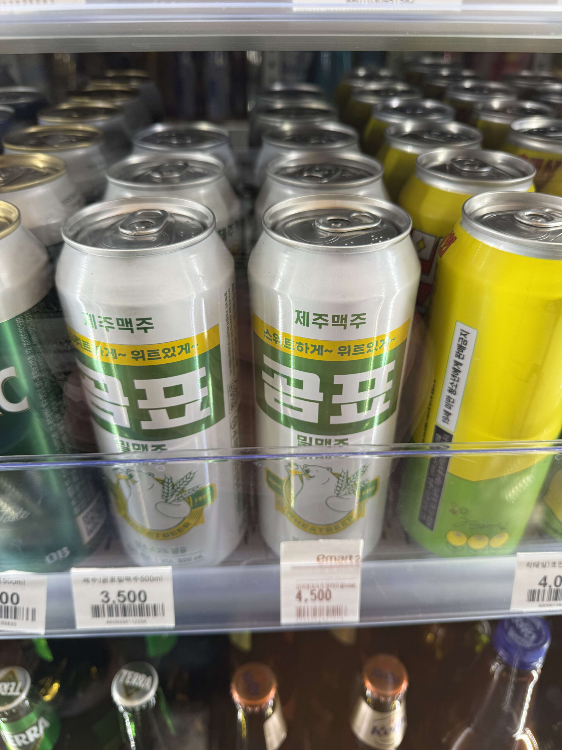 Gompyo wheat beer cans in a store refrigerator.