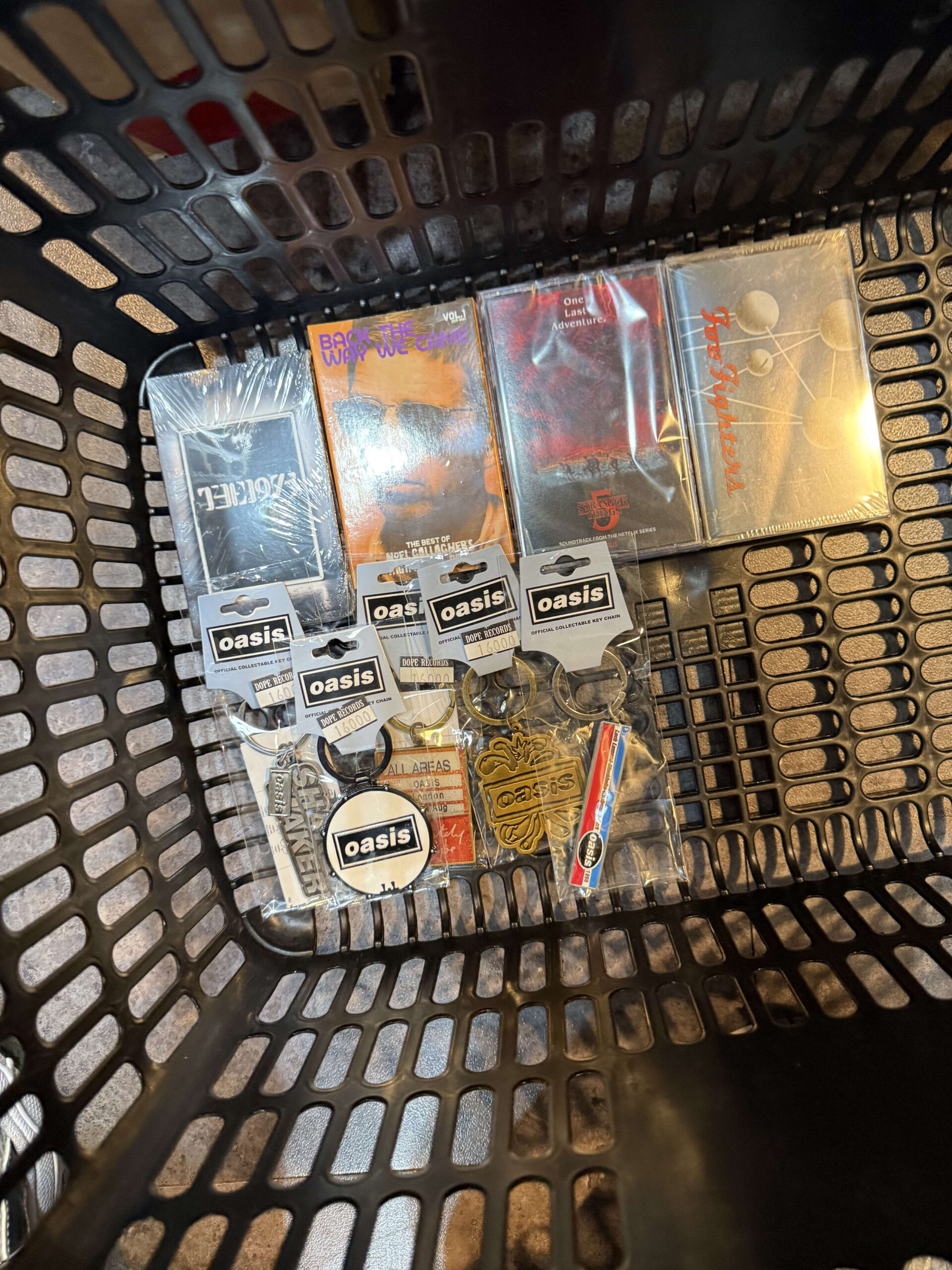 Basket with Oasis keychains and cassette tapes.