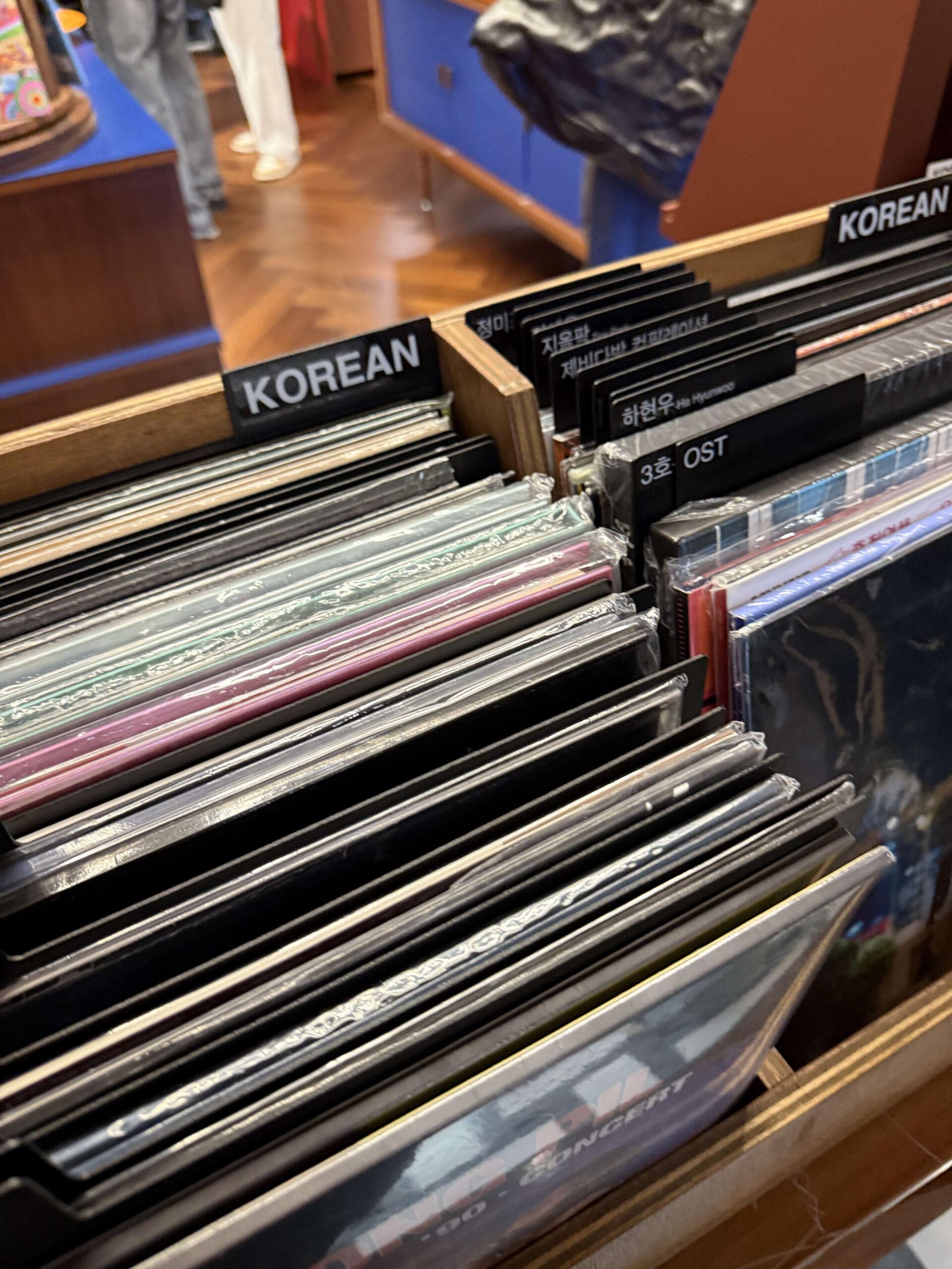 New vinyl records in a rack with KOREAN tabs.