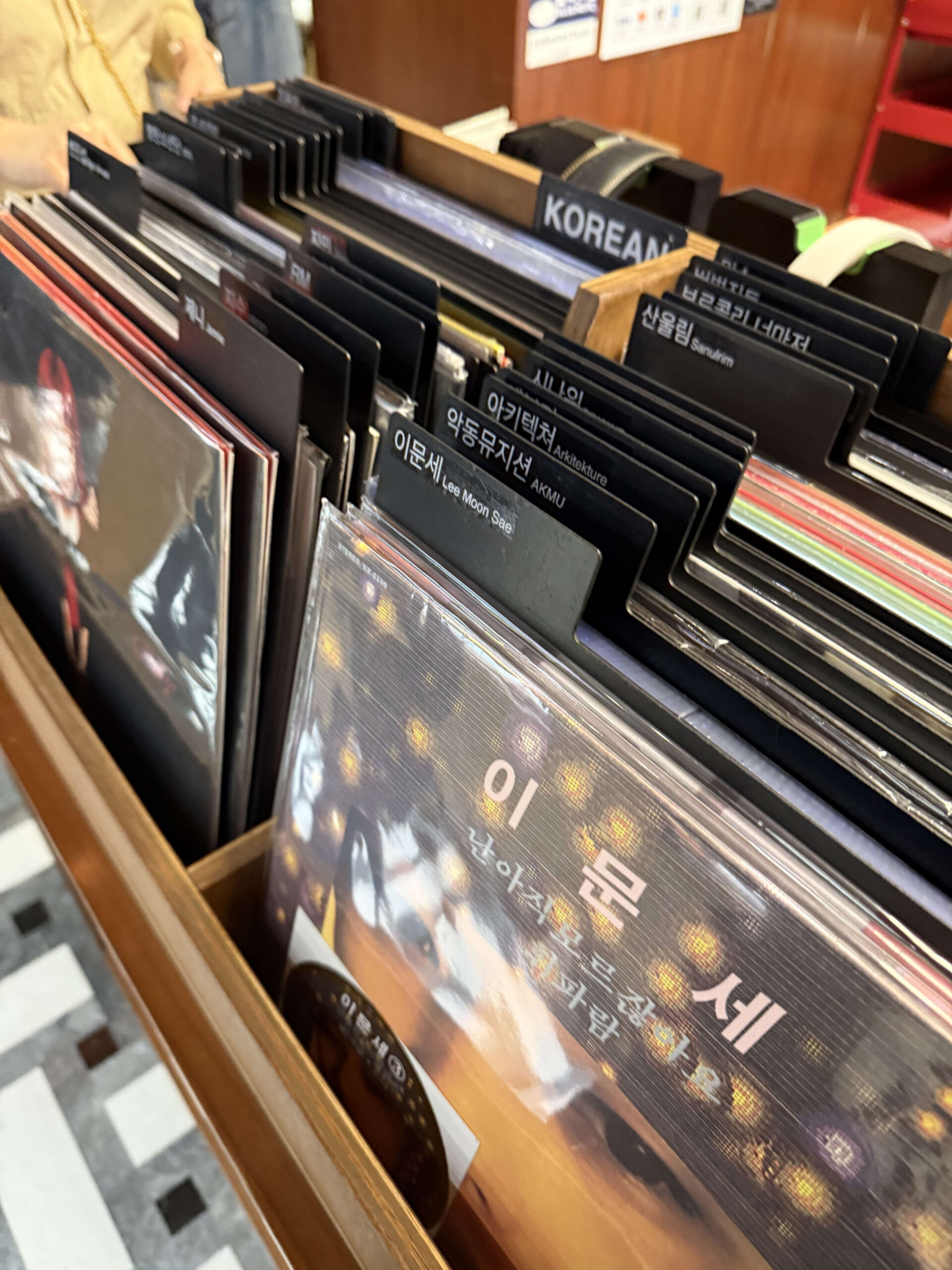 Records in a wooden rack with a KOREAN tab.