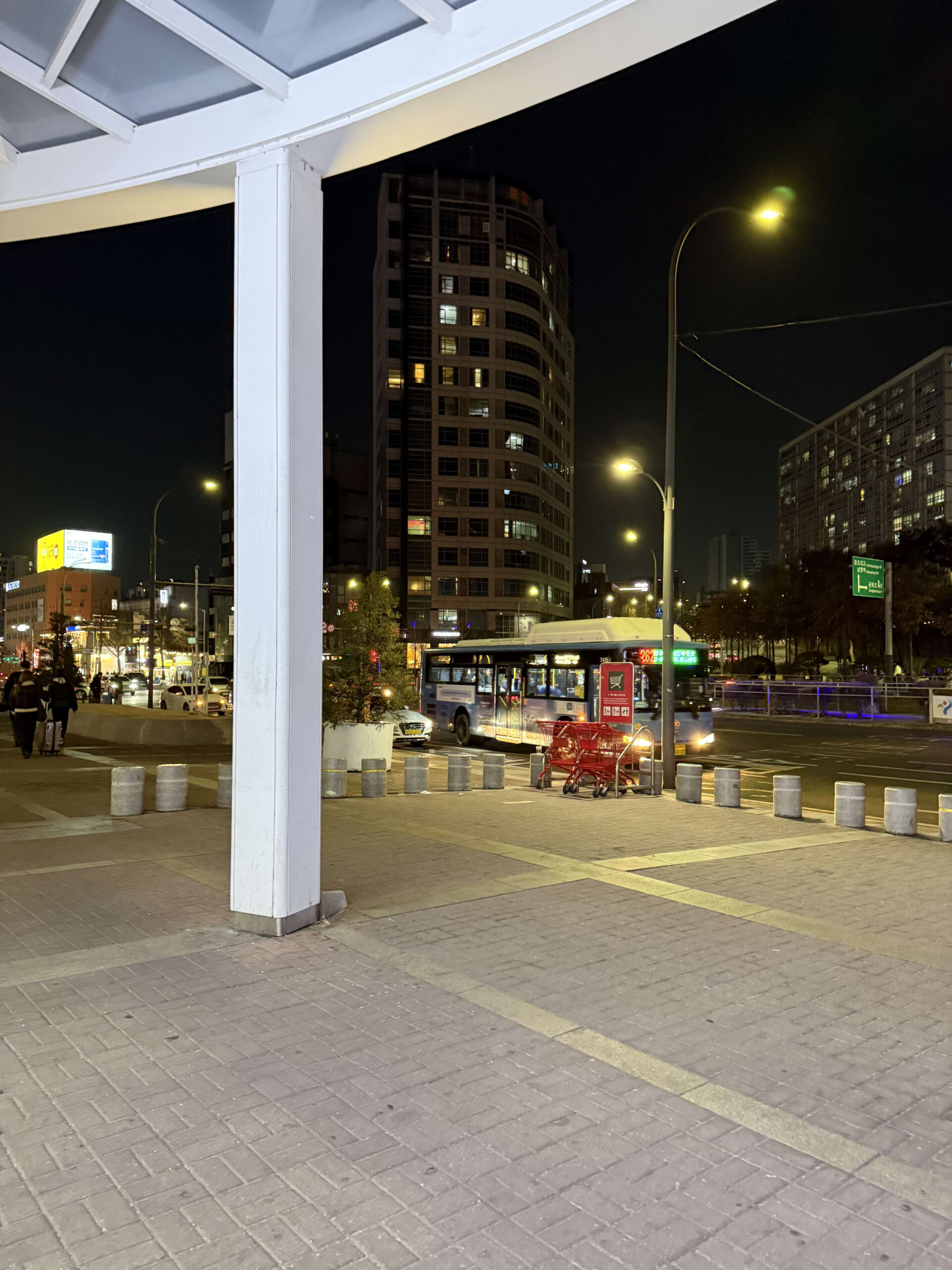 Seoul Station back exit at night with a red cart.