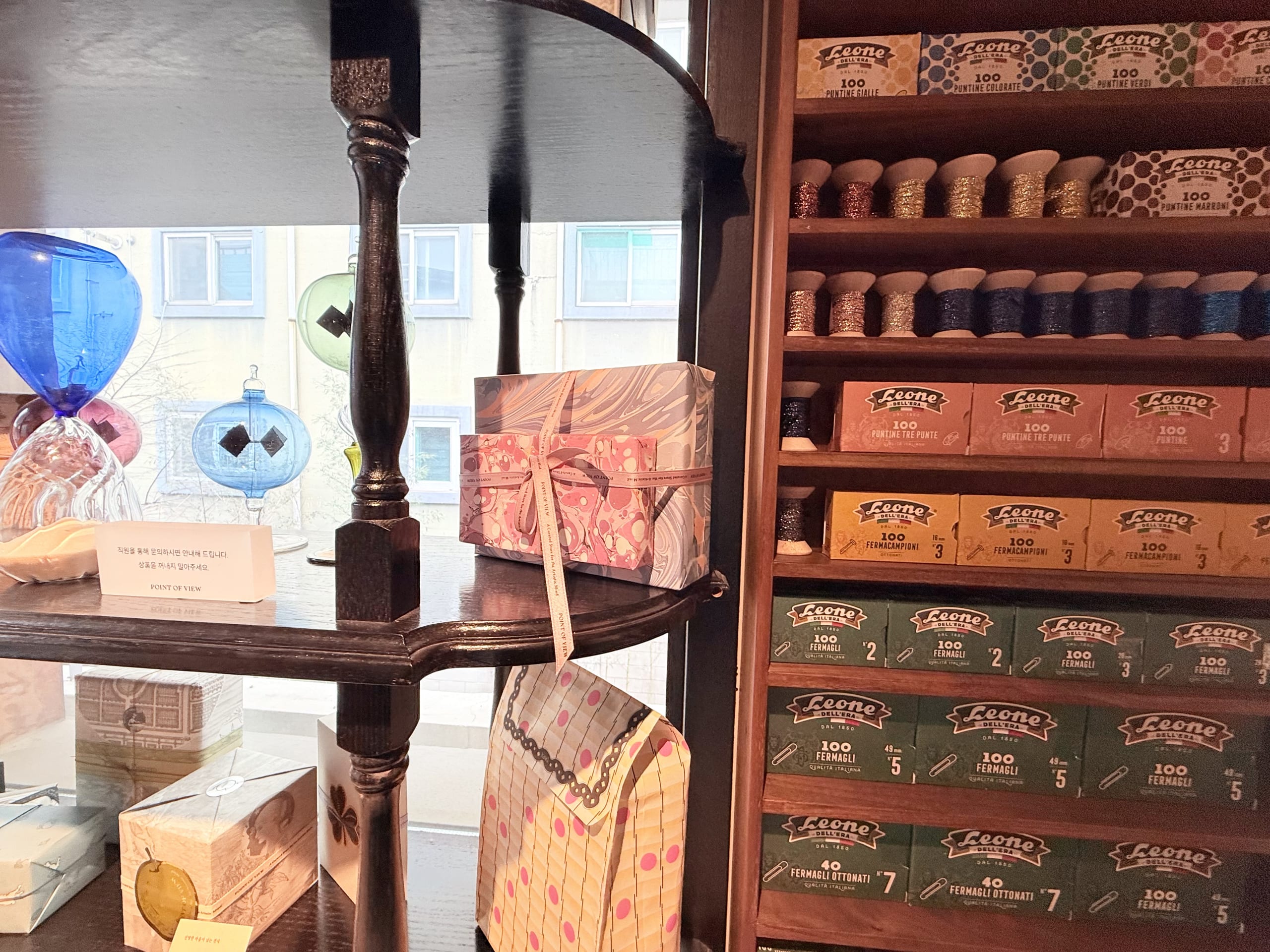 Vintage stationery boxes on wooden shelves.