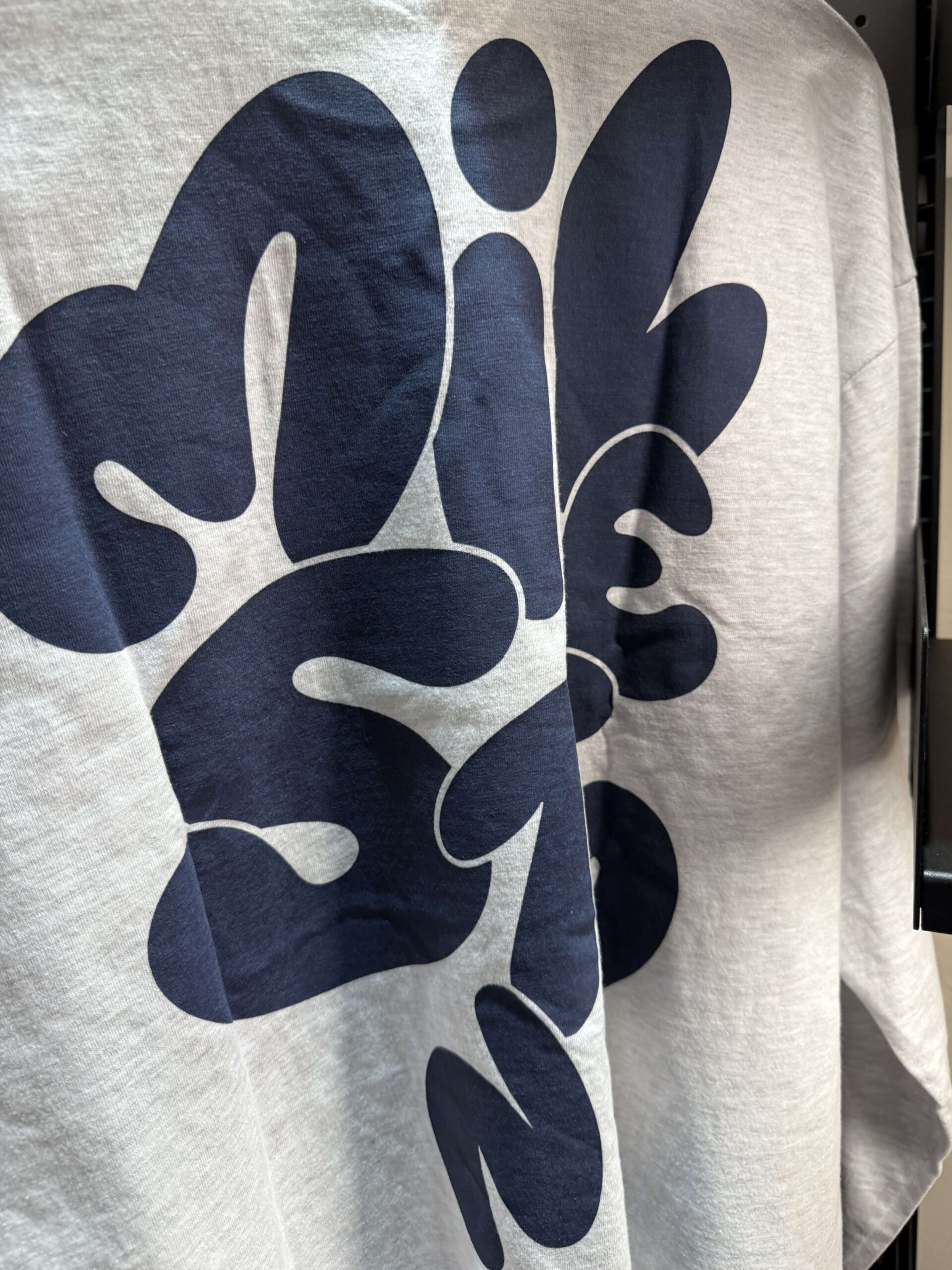 Gray sweatshirt with a large navy logo.
