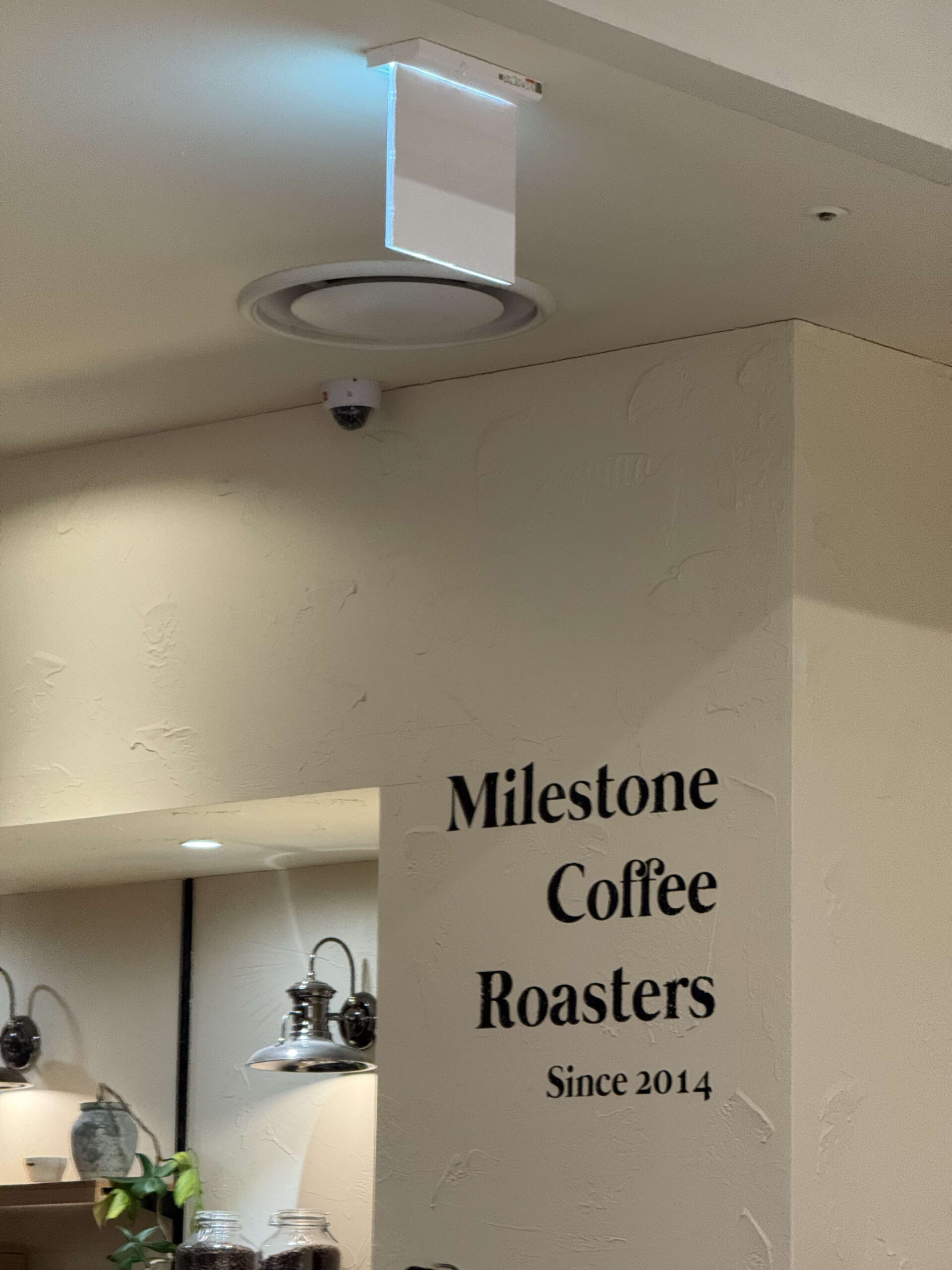 Milestone Coffee Roasters sign on a white wall