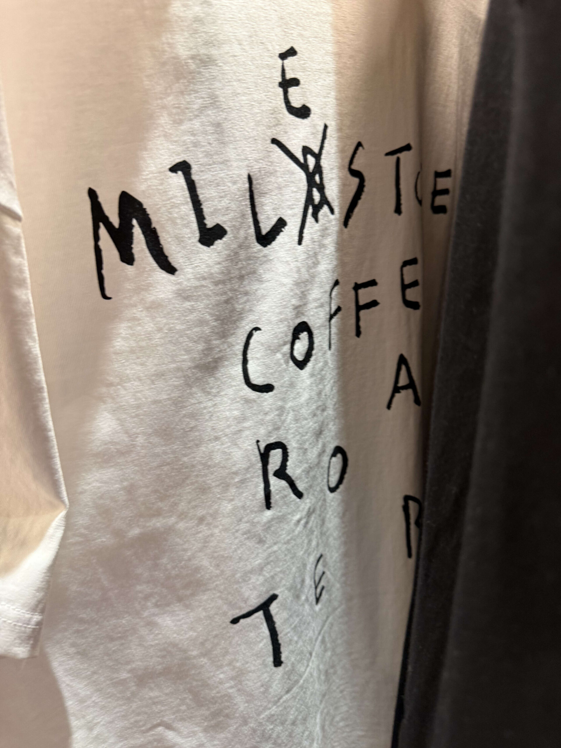 White T-shirt with milestone logo.