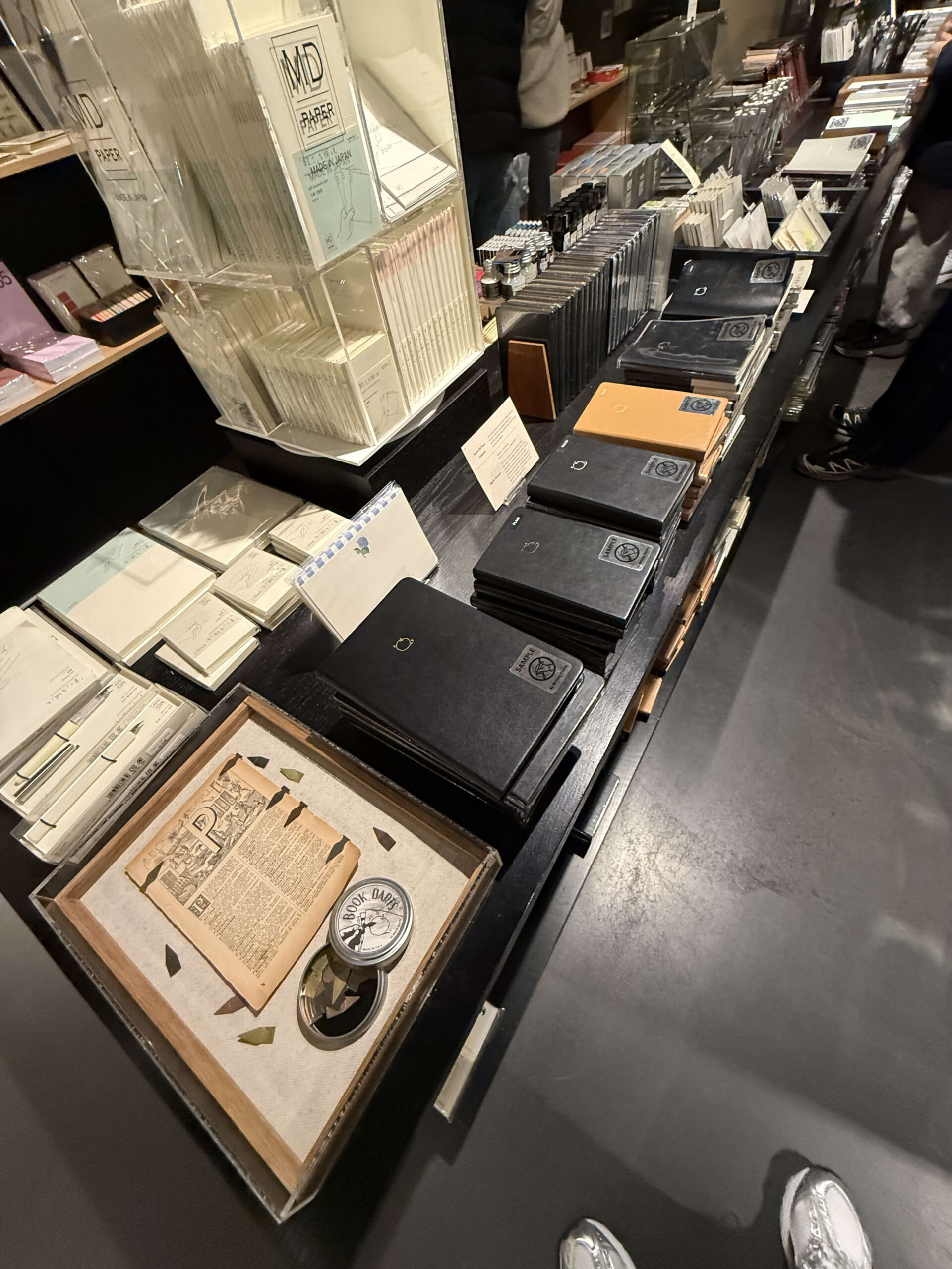 Store table with notebooks and vintage paper.
