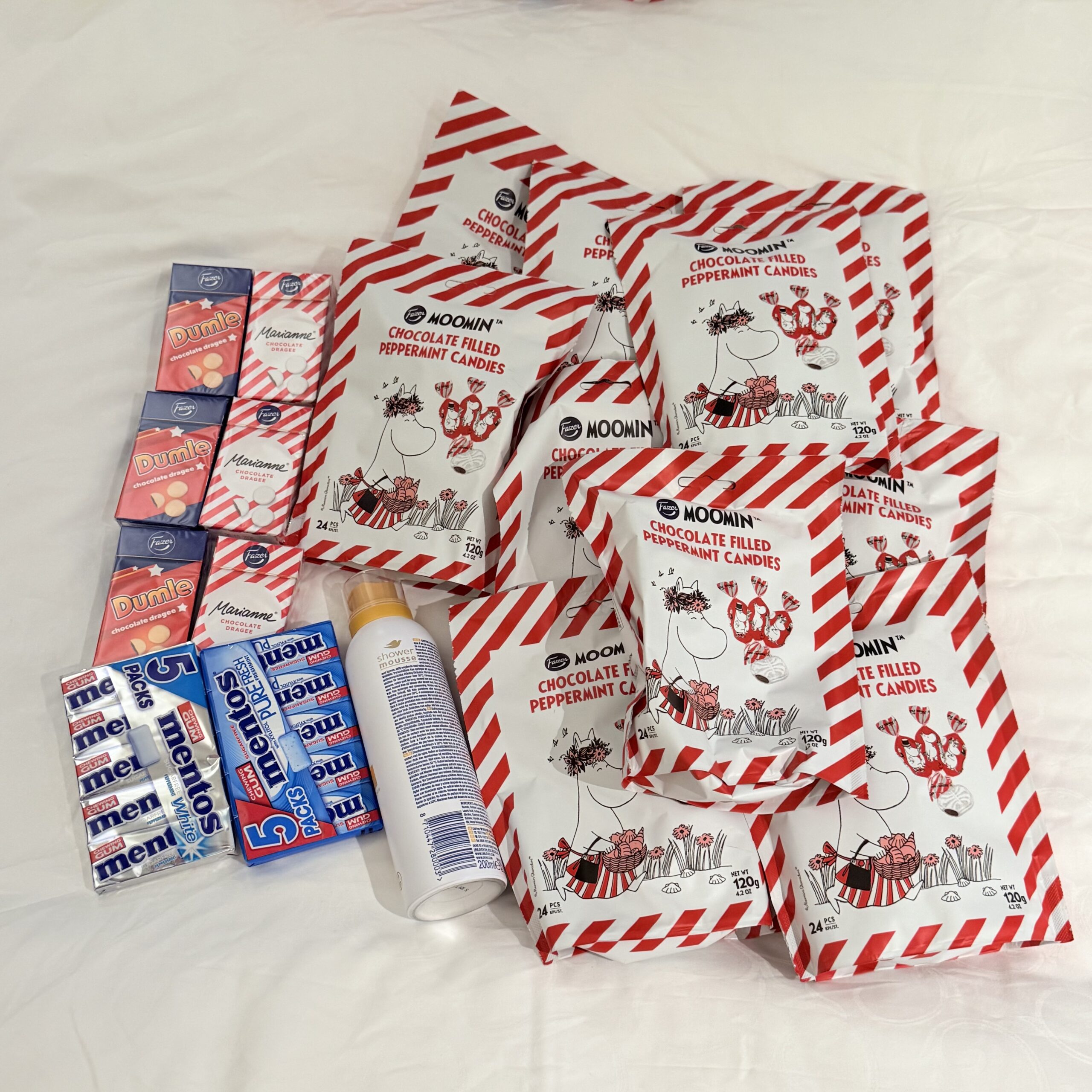 A mountain of red and white stripes spread across the pure white sheets.