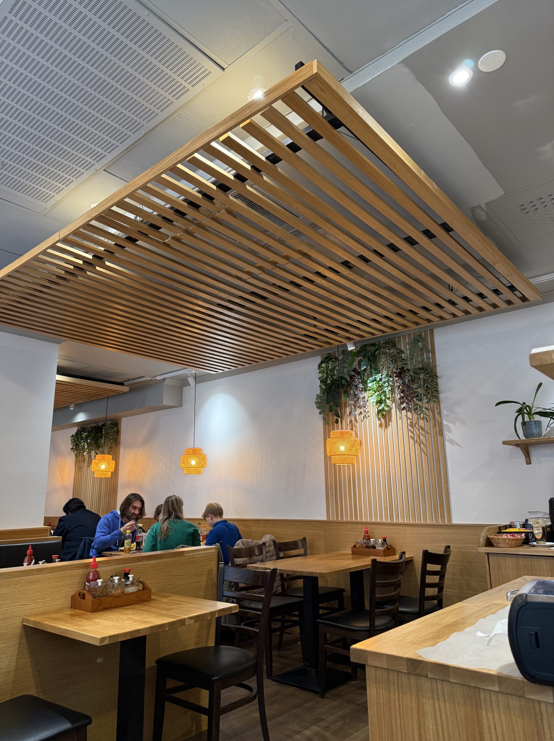 Modern interior with orange pendant lights and local condiments