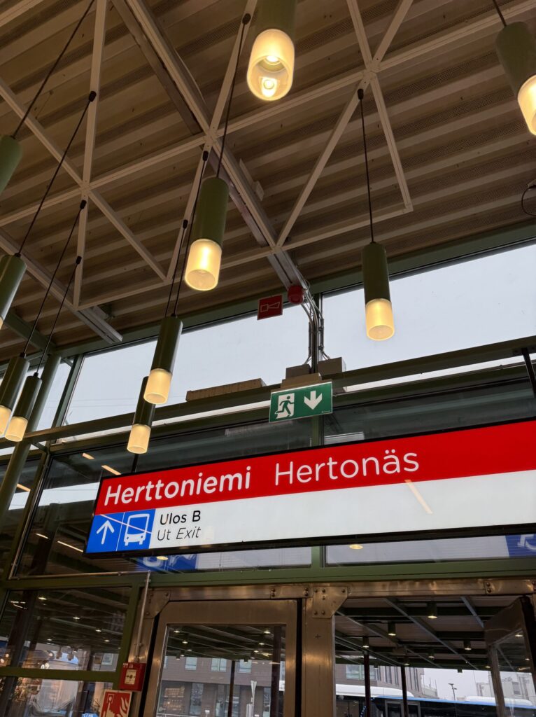 Herttoniemi station sign with pendant lights