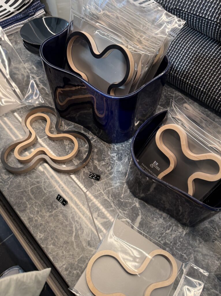 Wooden trivet resting inside a deep blue Aalto vase