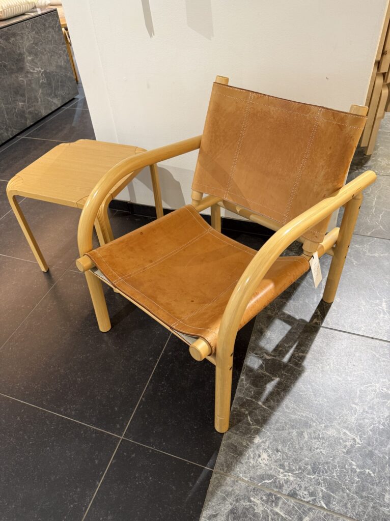 Amber leather lounge chair on a dark tile floor