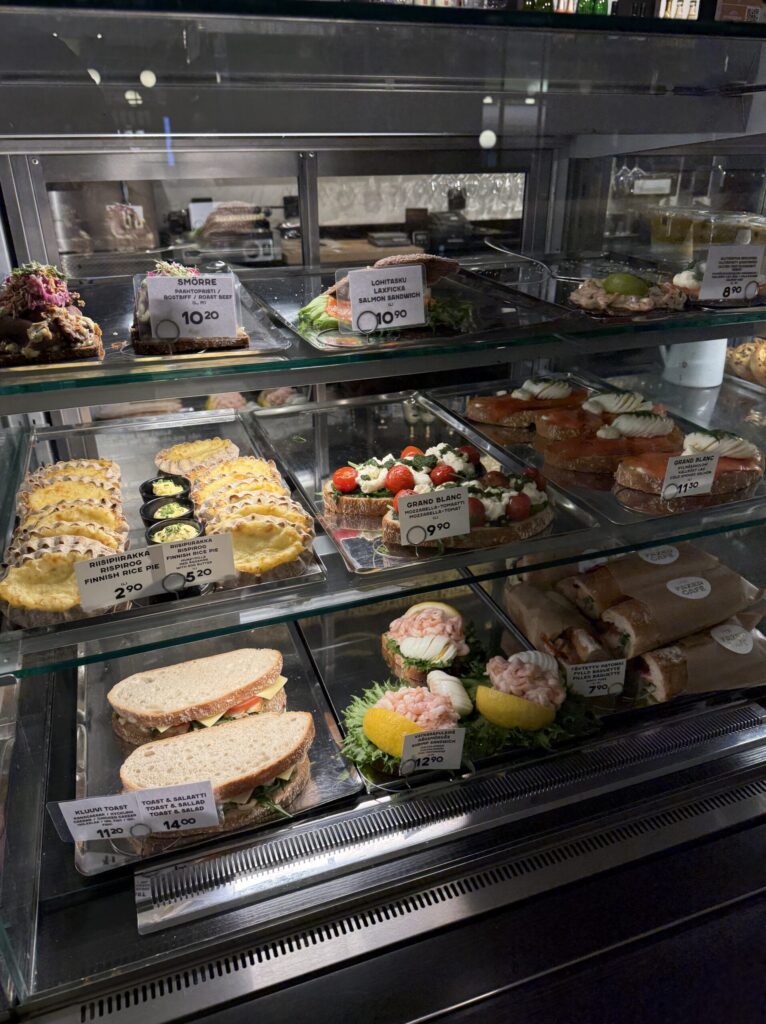 Display case at Fazer Cafe showing Karelian pies and open-faced sandwiches