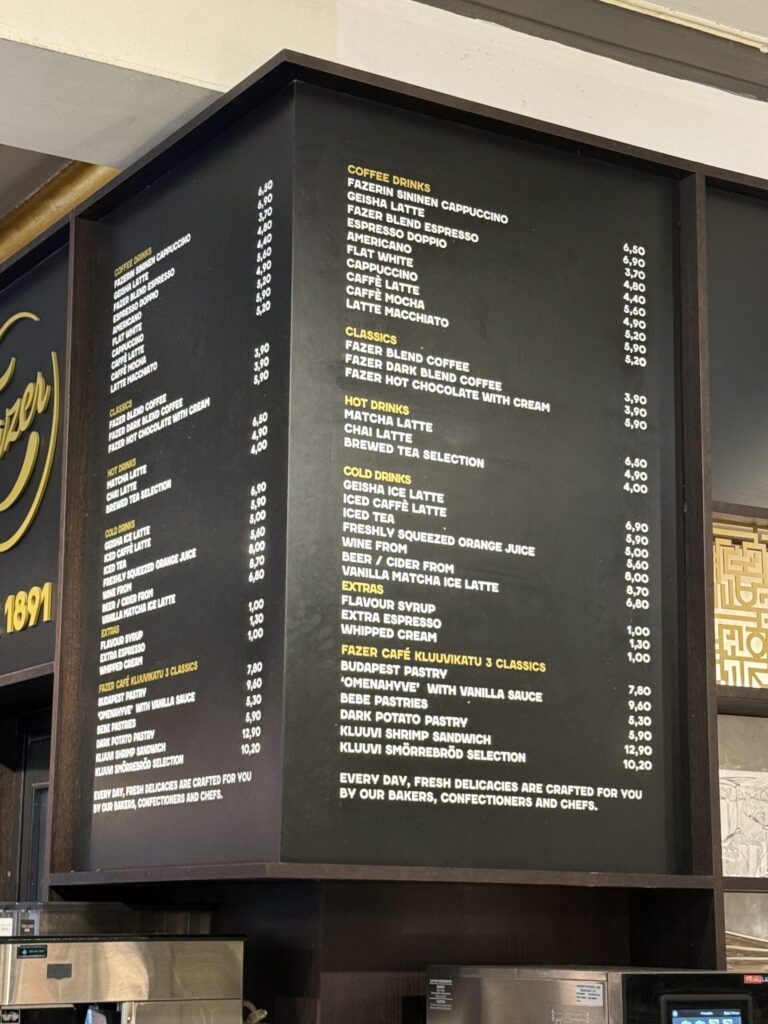 Menu board at Fazer Cafe showing coffee and beer options