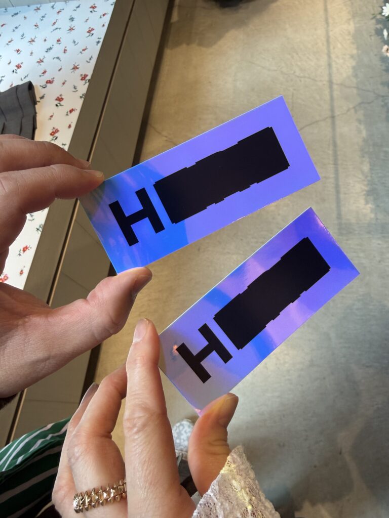 Holographic entrance sticker with black H logo