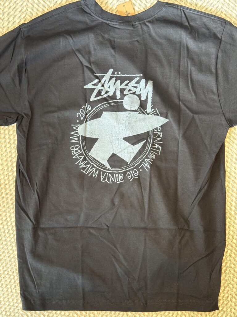 A freshly unfolded black Stussy and eYe JUNYA WATANABE MAN collaboration t-shirt